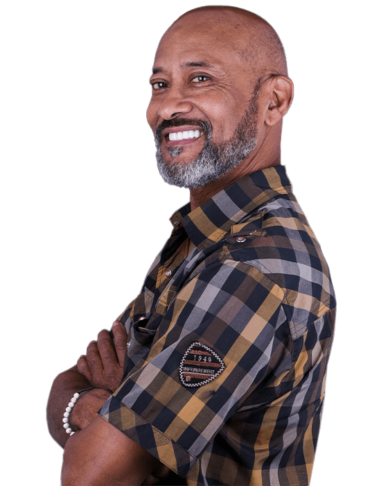 bald black man smiling after getting 3 on 6 dental implants in Mexico