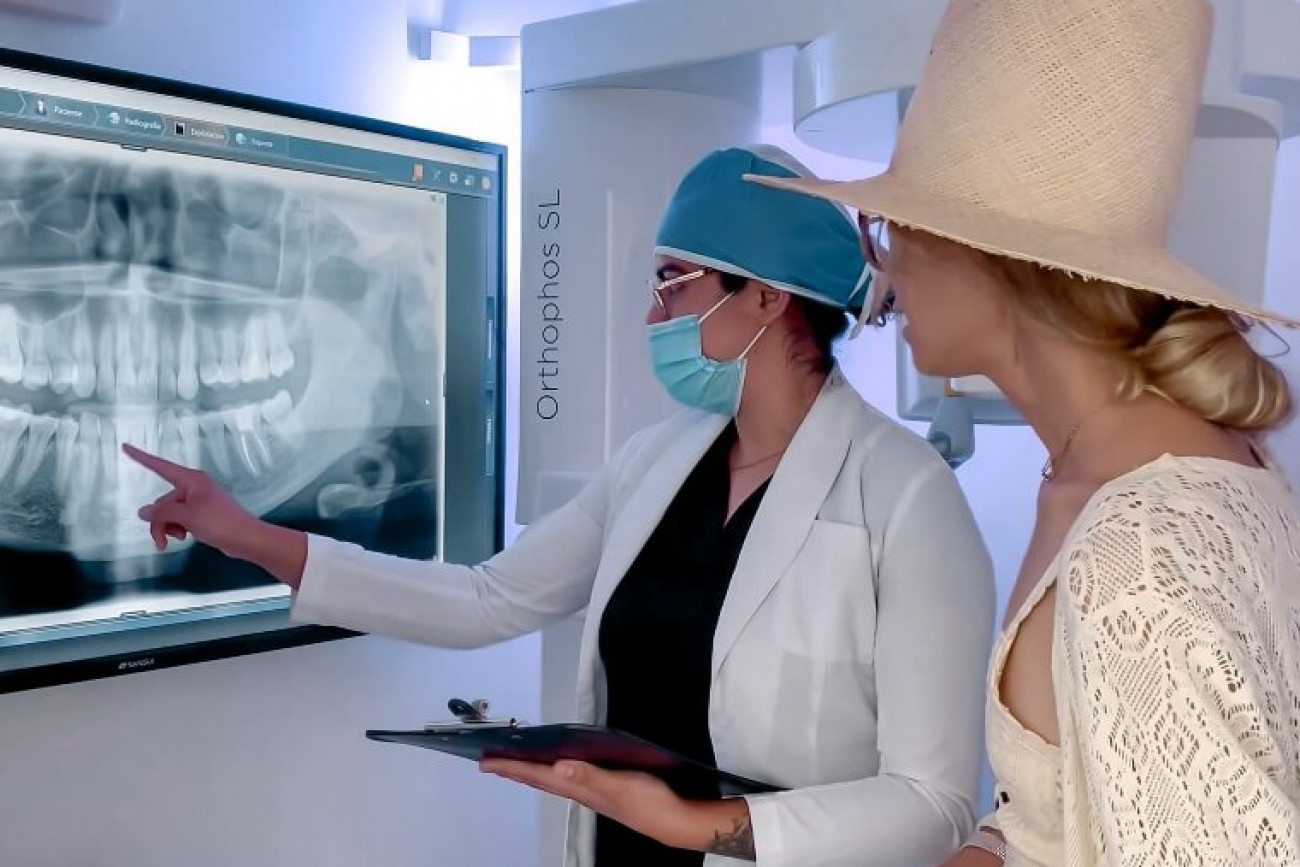 dentist at advanced cabo dentistry explaining smile makeover to a female patient
