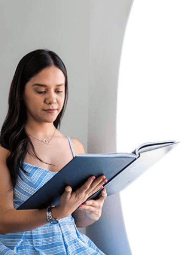 young female patient at Advanced Cabo dentistry checking out a dental treatments catalog