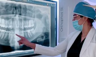 Dentist of Advanced Cabo Dentistry examining the x-ray of a patient who got dental crowns