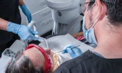 dentist in Cabo San Lucas performing a painless dental implant surgery