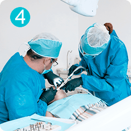 Dentist performing dental implant surgery using a surgical guide